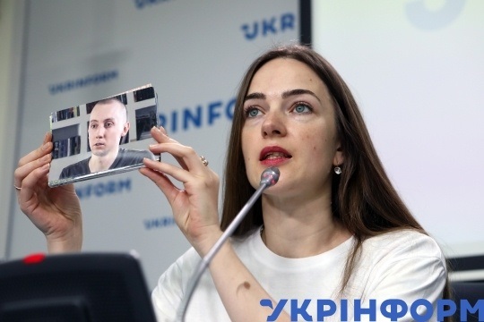 Правозащитница Александра Матвийчук показывает фото Станислава Асеева
