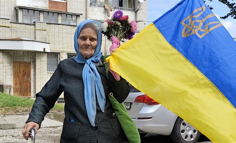 Старша жінка з Херсонщини розчулила мережу на День прапора синьо-жовтим стягом і шкарпетками